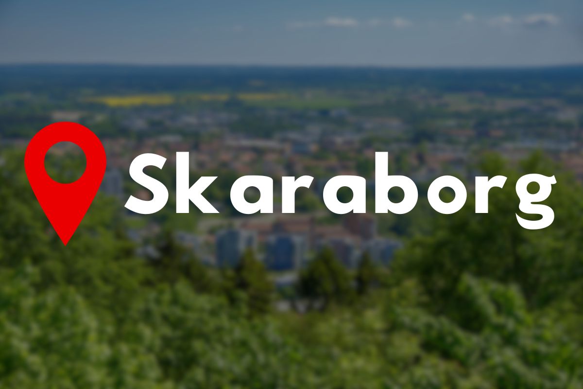 Guide till vandring Skaraborg Vildmarknaden.se Skaraborg-logotyp med kartnålssymbol framför utsikt över Skövde och landskap.